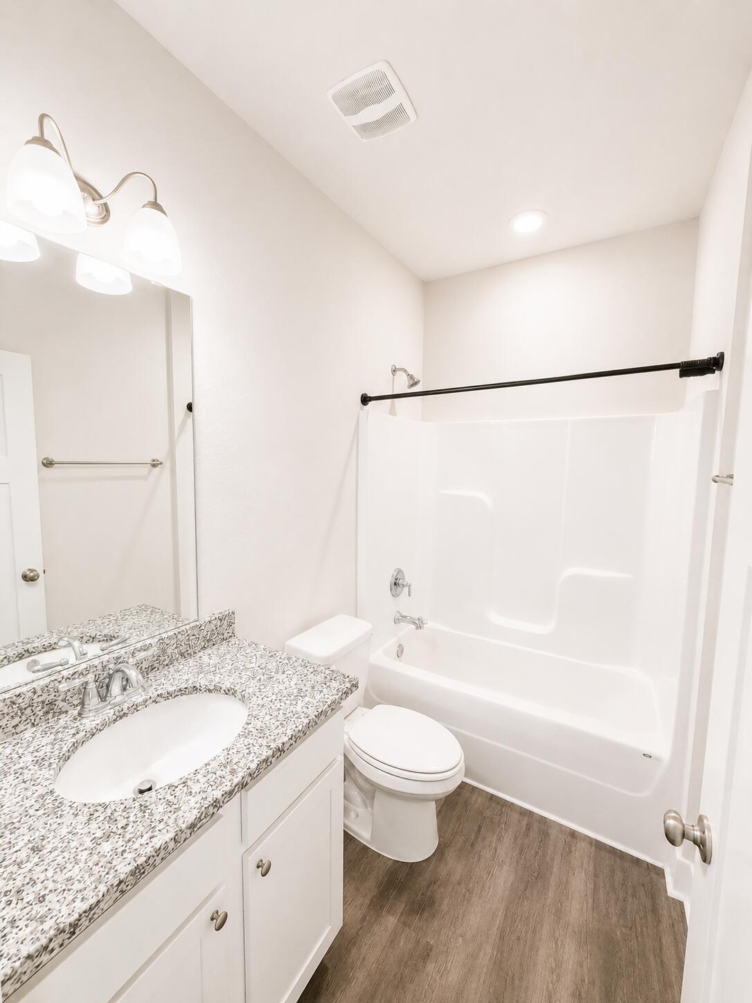 734 Quintana Street Crestview, FL 32539 - Photo 9 of 16 a bathroom with a granite countertop sink a toilet and shower