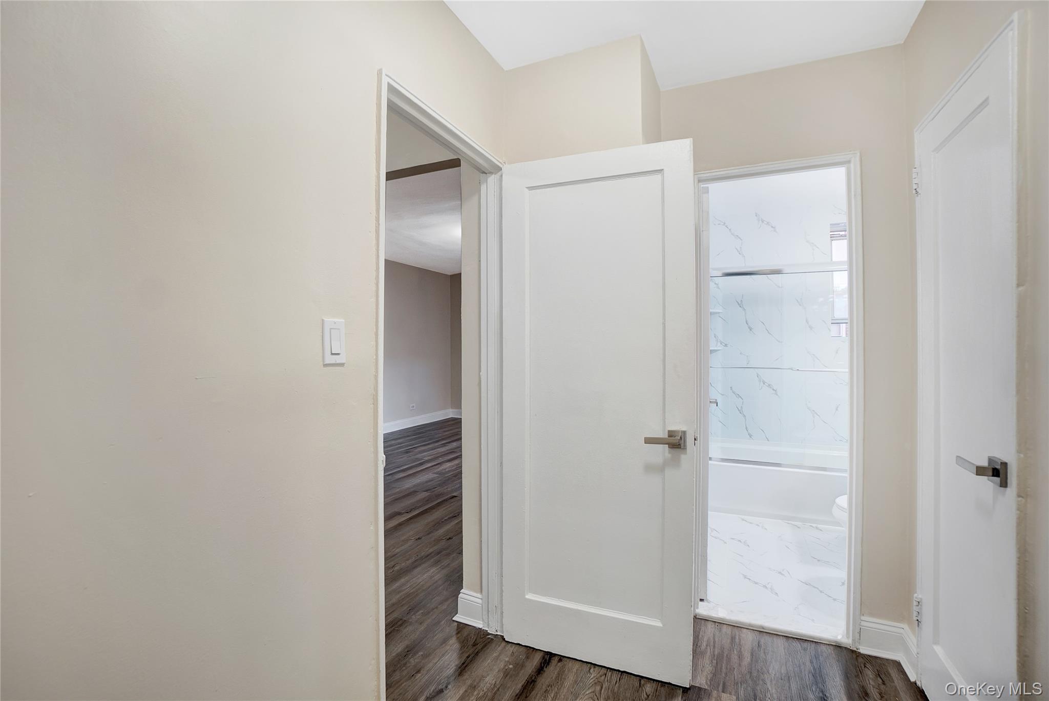 105-24 64th Road, Unit 4L Queens, NY 11375 - Photo 11 of 14 an empty room with wooden floor