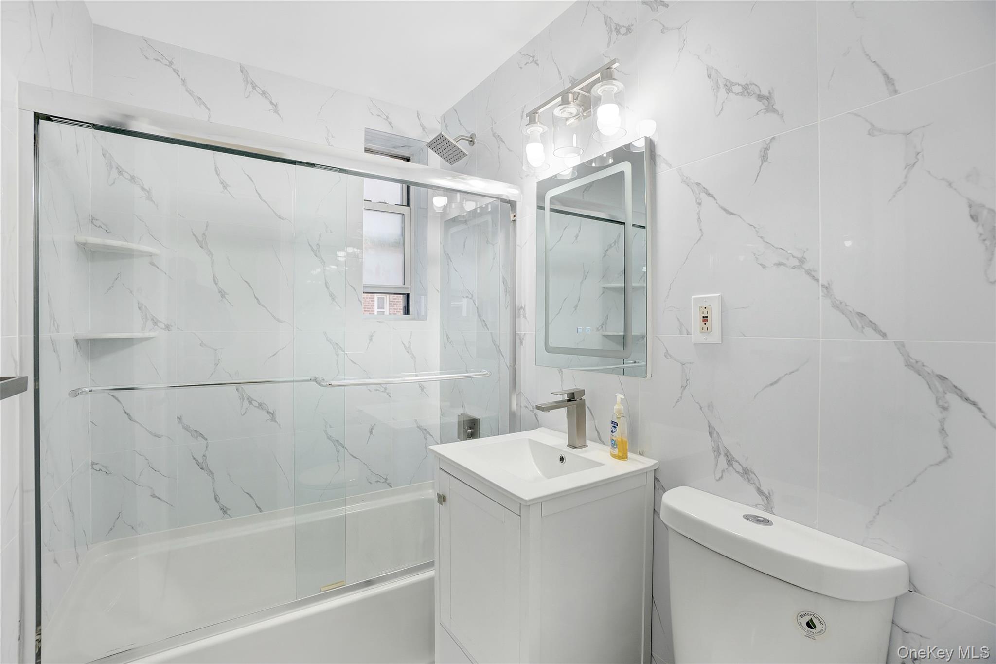 105-24 64th Road, Unit 4L Queens, NY 11375 - Photo 12 of 14 a bathroom with a sink a toilet and shower