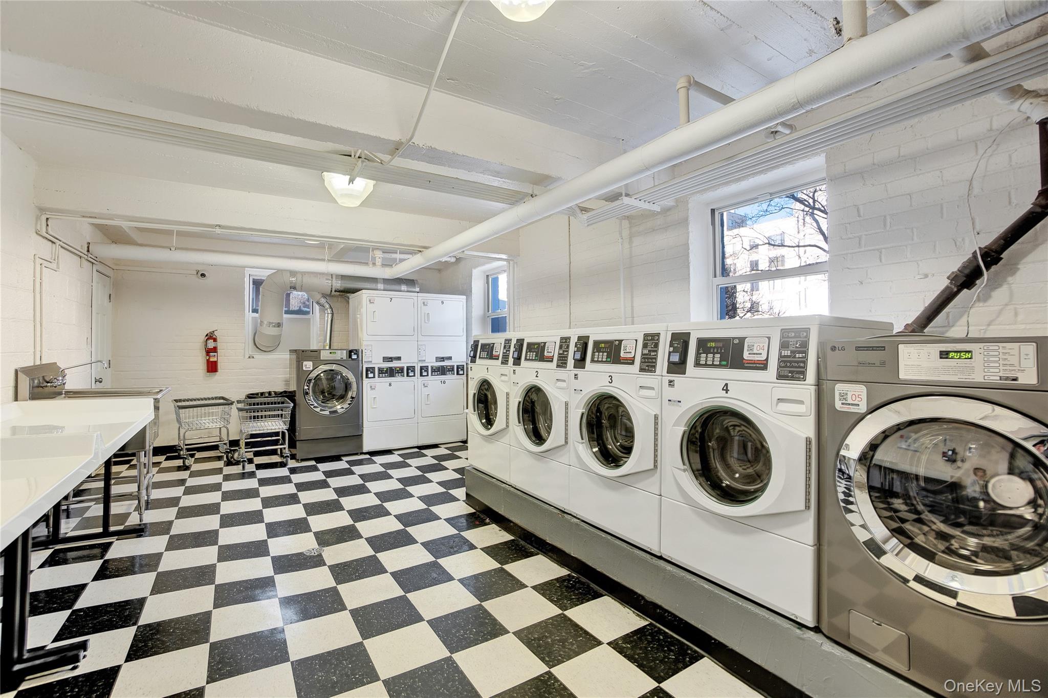 105-24 64th Road, Unit 4L Queens, NY 11375 - Photo 13 of 14 a utility room with dryer and washer