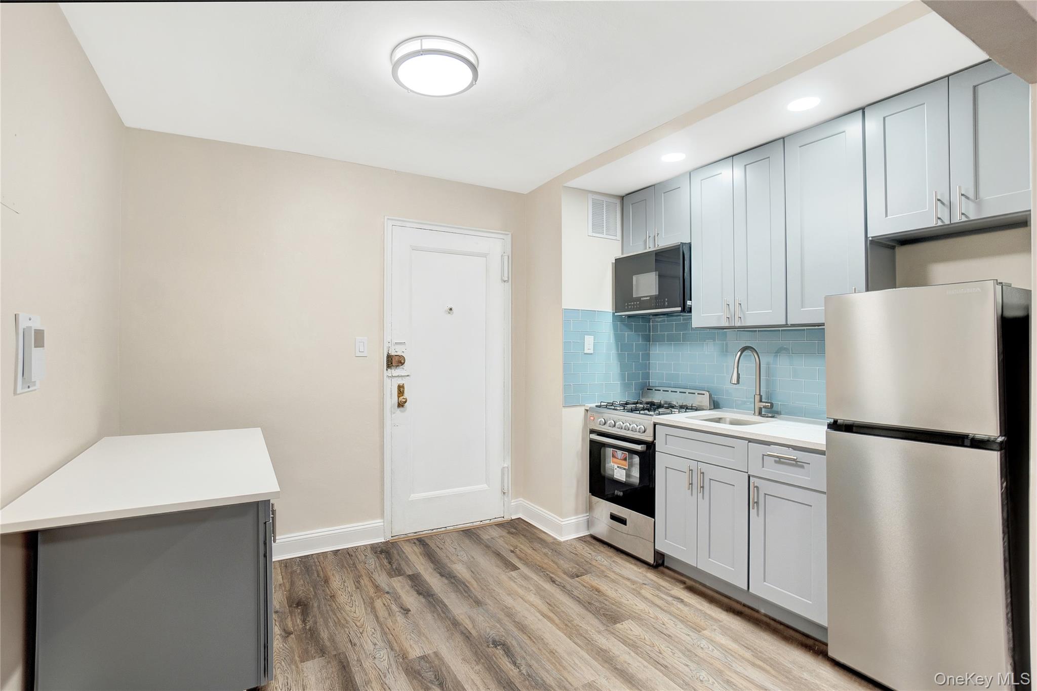 105-24 64th Road, Unit 4L Queens, NY 11375 - Photo 8 of 14 a kitchen with a sink a stove and refrigerator