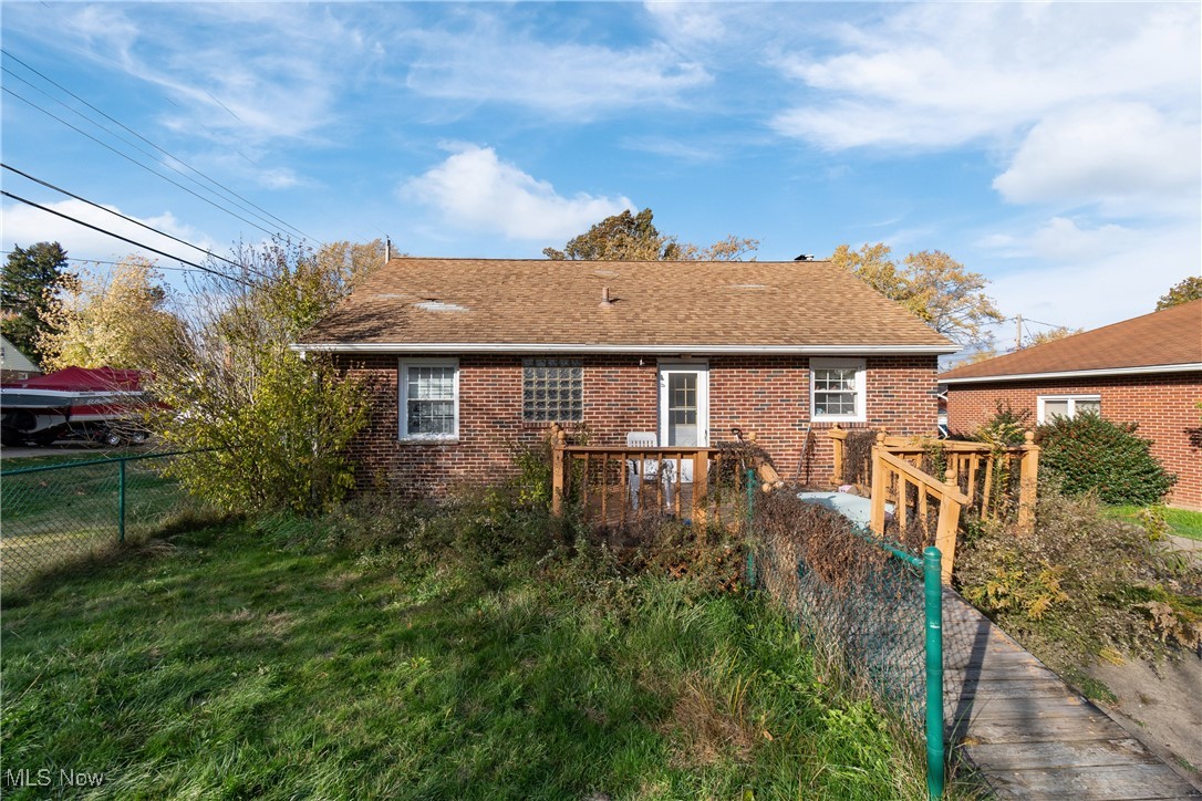 984 Roseland Road Alliance, OH 44601 - Photo 27 of 28 Rear view of house featuring a shingled roof and brick siding