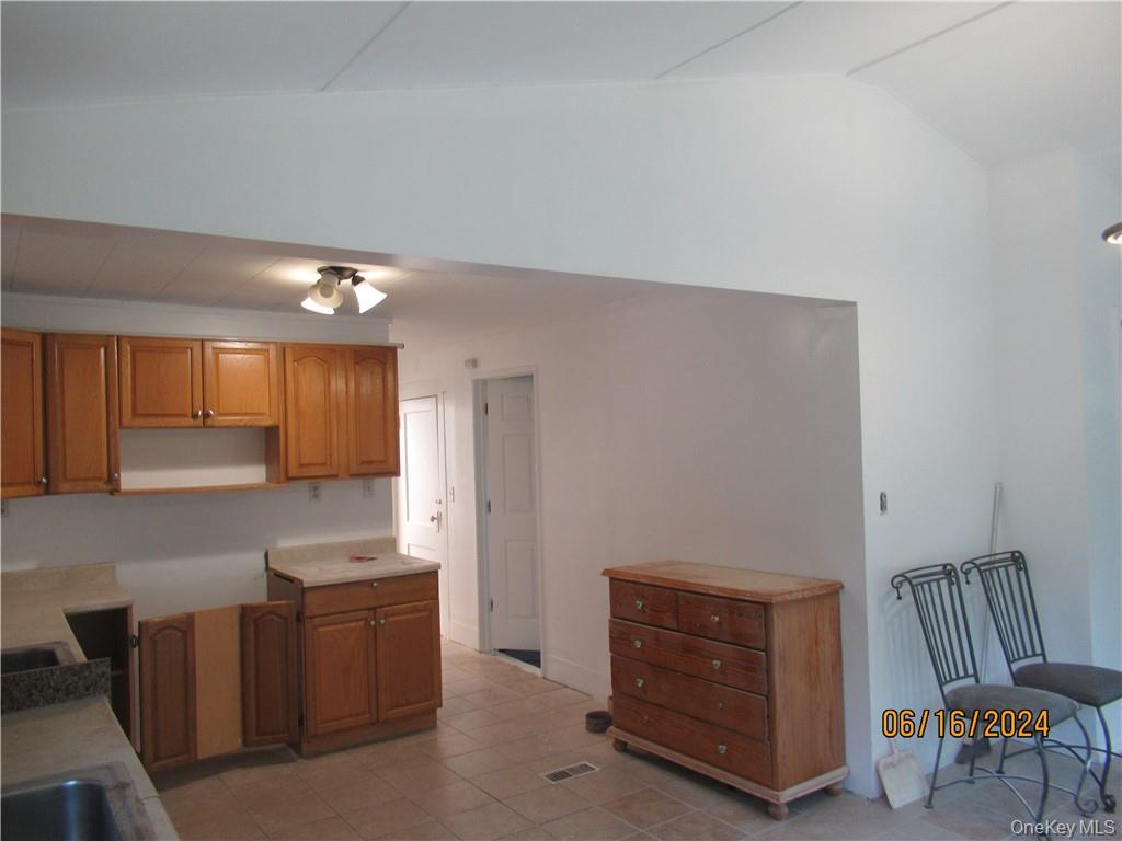 82 North Road Bloomingburg, NY 12721 - Photo 5 of 19 Kitchen featuring lofted ceiling and light tile floors