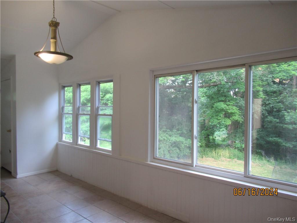 82 North Road Bloomingburg, NY 12721 - Photo 6 of 19 Dining area featuring tile floors and lofted ceiling