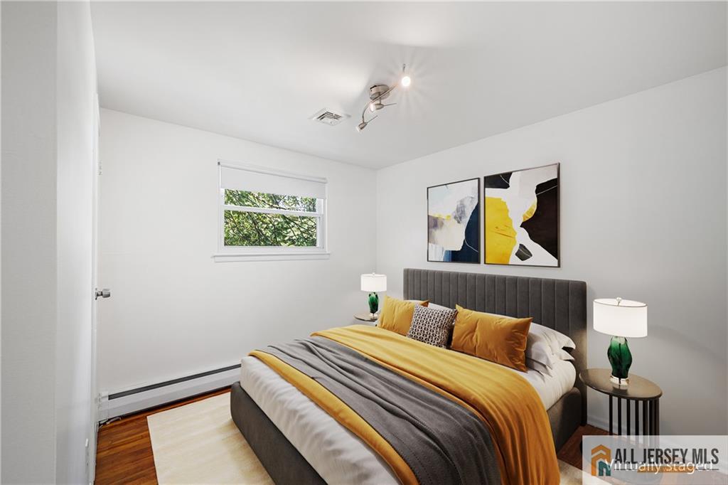 21 Eardley Road Edison, NJ 08817 - Photo 16 of 40 a bedroom with a bed and a painting on the wall