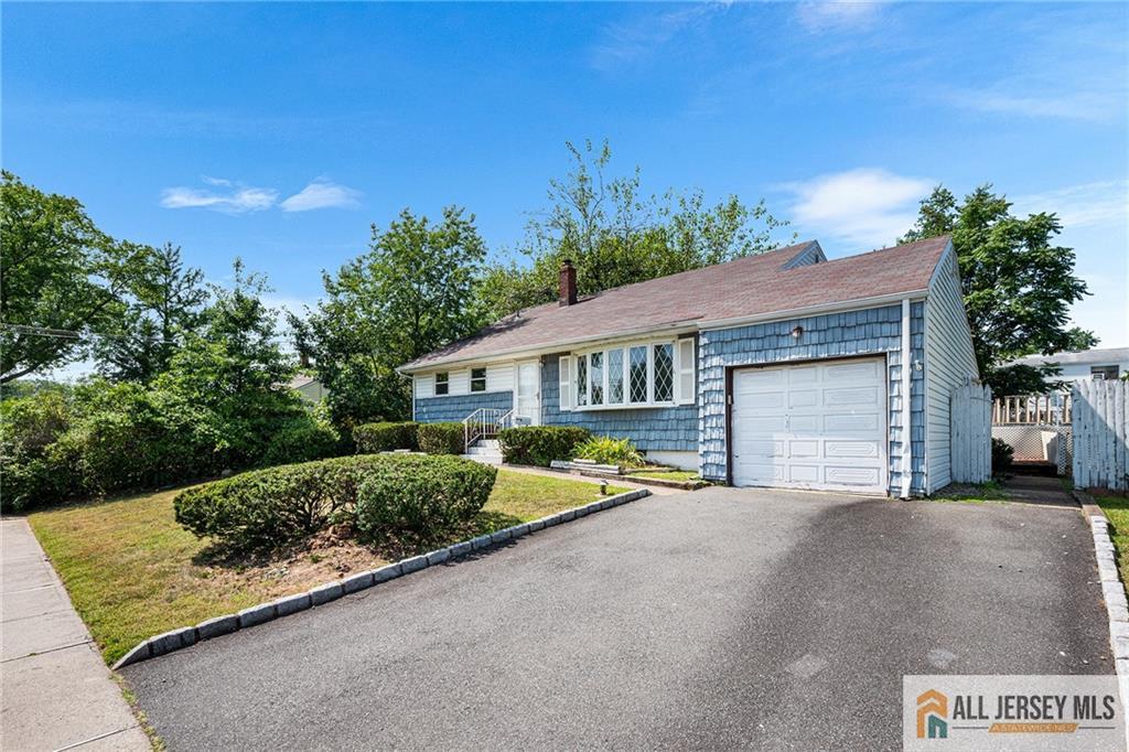 21 Eardley Road Edison, NJ 08817 - Photo 2 of 40 a front view of a house with a yard and garage