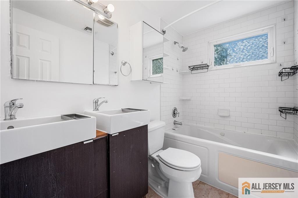 21 Eardley Road Edison, NJ 08817 - Photo 22 of 40 a bathroom with a sink toilet vanity and bathtub