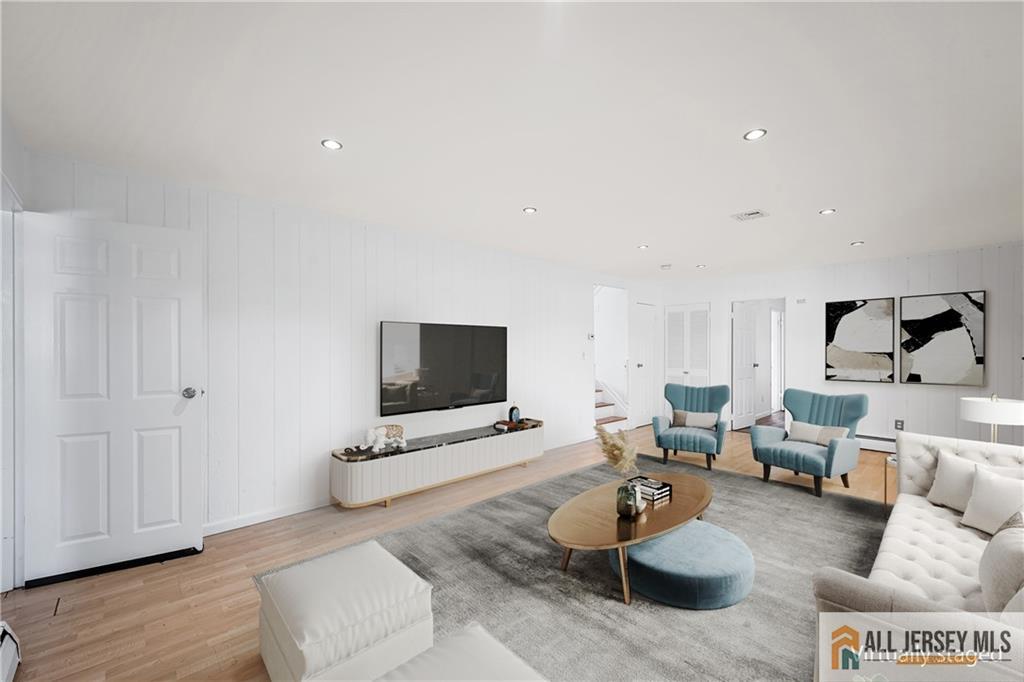 21 Eardley Road Edison, NJ 08817 - Photo 24 of 40 a living room with furniture and a flat screen tv