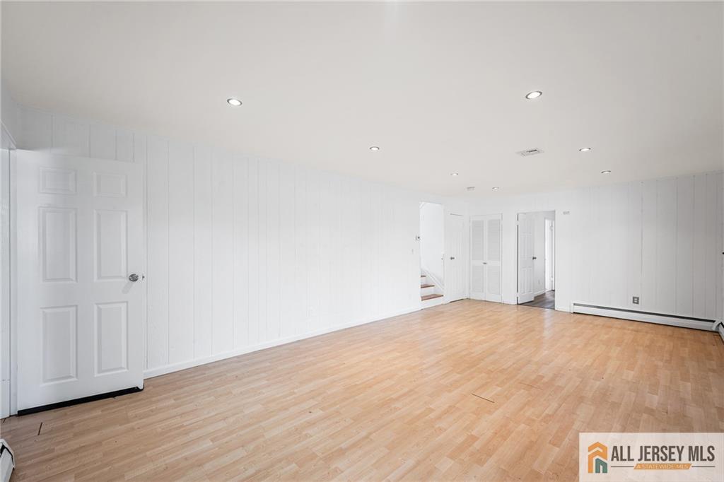 21 Eardley Road Edison, NJ 08817 - Photo 25 of 40 a view of an empty room with wooden floor