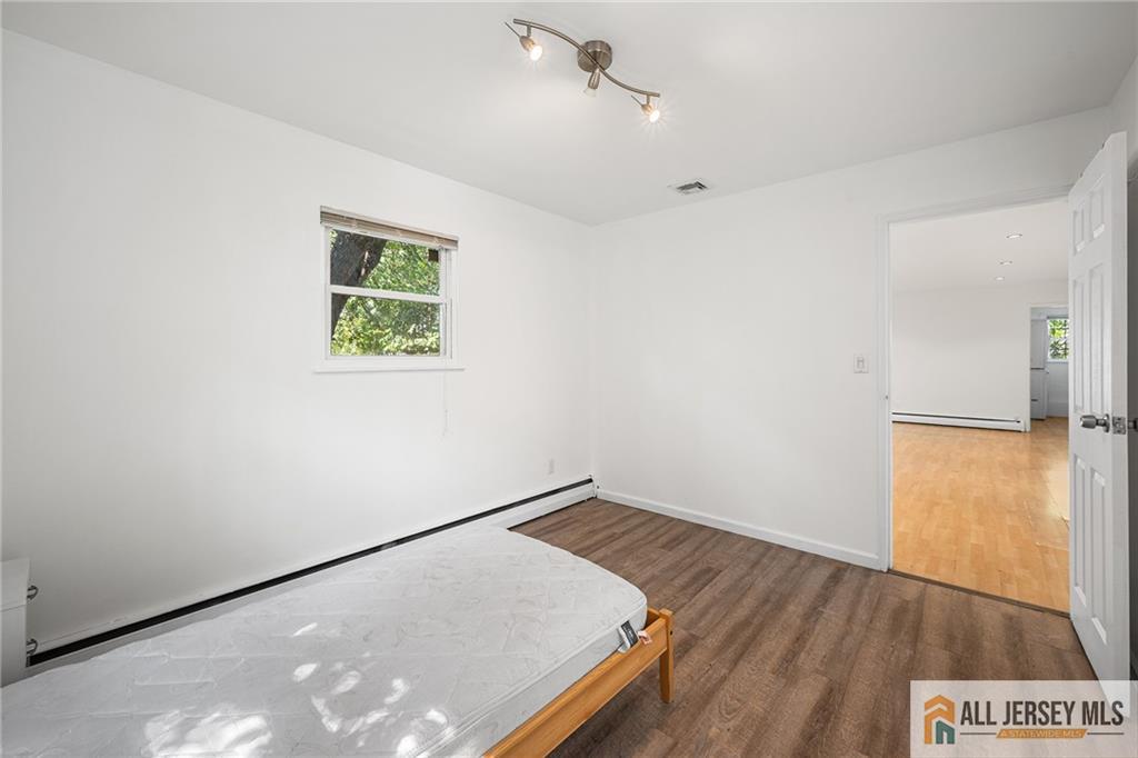 21 Eardley Road Edison, NJ 08817 - Photo 27 of 40 an empty room with a window and wooden floor