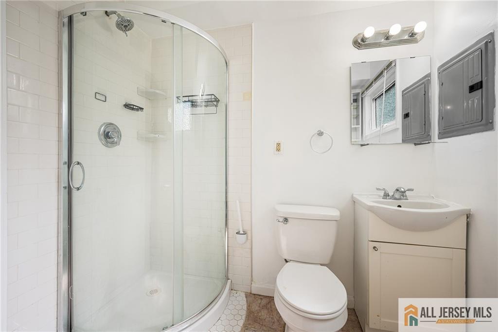 21 Eardley Road Edison, NJ 08817 - Photo 29 of 40 a white toilet sitting next to a bath tub