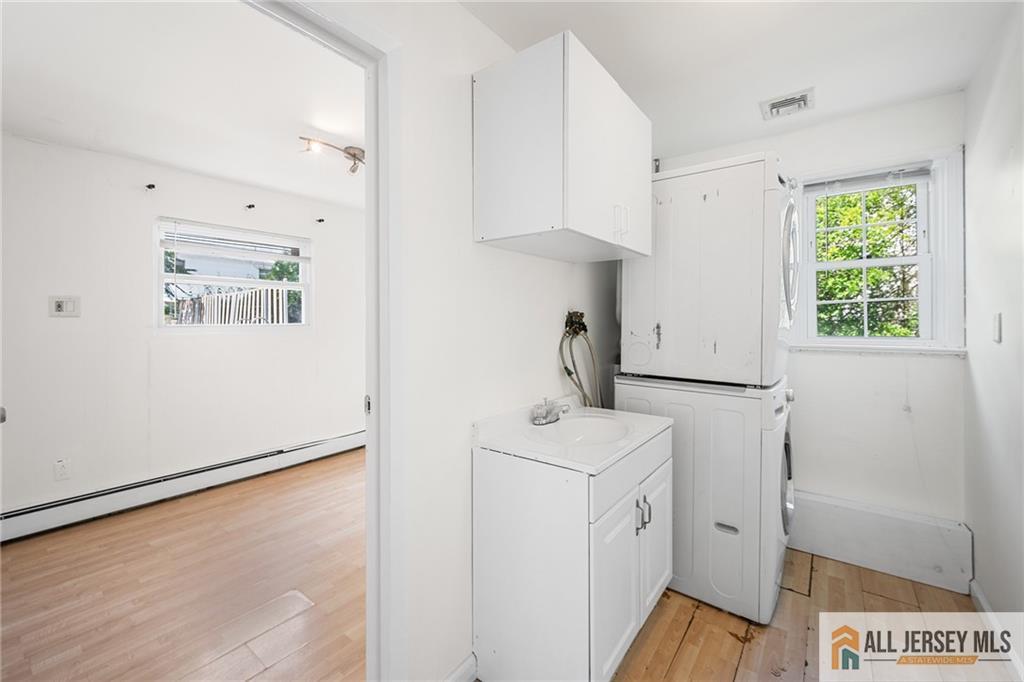 21 Eardley Road Edison, NJ 08817 - Photo 30 of 40 a utility room with cabinets washer and dryer