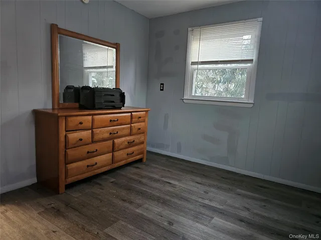 a room with wooden floors and window