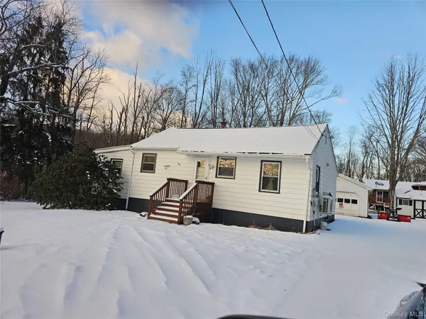 a view of a house with a snow in the yard