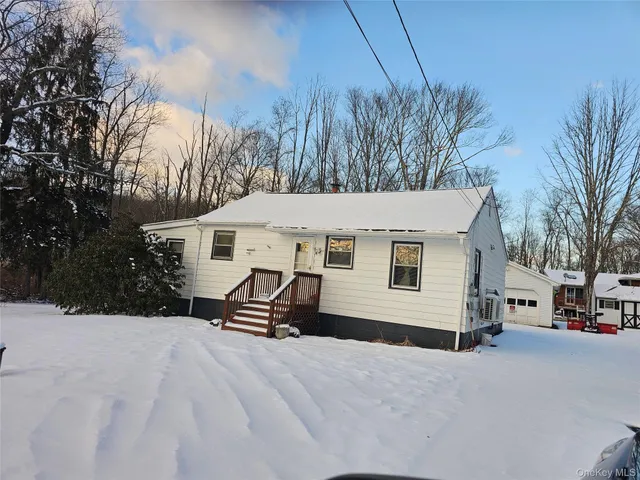 a view of a house with a snow in the yard