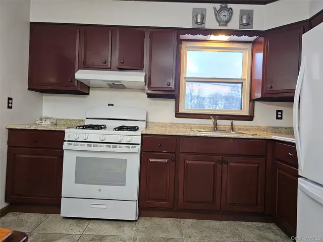 a kitchen with a stove cabinets and a sink