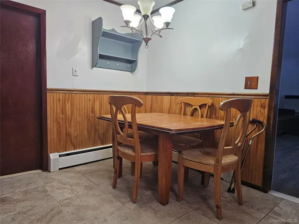 a dining room with a wooden table and chairs