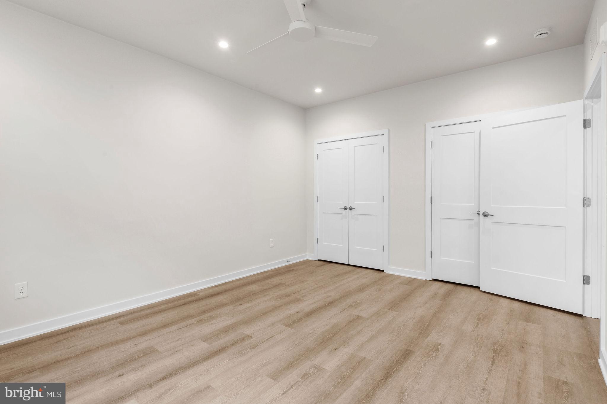 26 South York Road, Unit 208 Hatboro, PA 19040 - Photo 18 of 52 an empty room with wooden floor and white walls