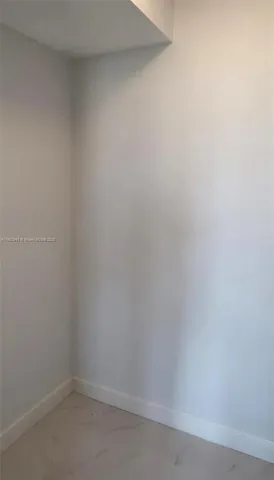 a kitchen with stainless steel appliances white cabinets and a refrigerator