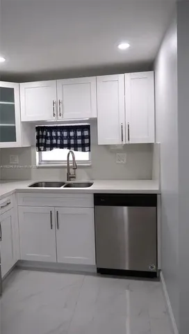 a metallic refrigerator freezer sitting in a kitchen