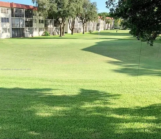 an empty room with windows and ceiling fan