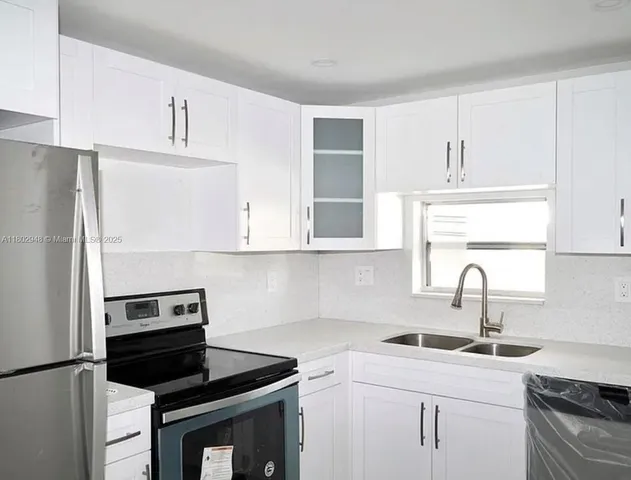 a kitchen with a sink stove and refrigerator