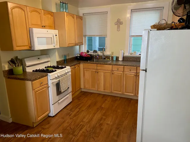 a kitchen with cabinets a sink and appliances