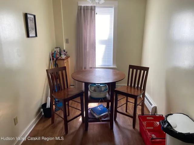 a view of a room with furniture and wooden floor
