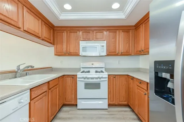 a kitchen with stainless steel appliances granite countertop a stove and a refrigerator