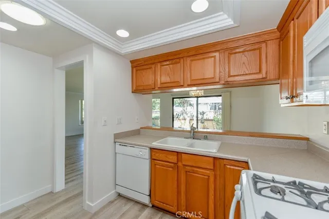 a kitchen with stainless steel appliances granite countertop a sink and dishwasher with wooden floor