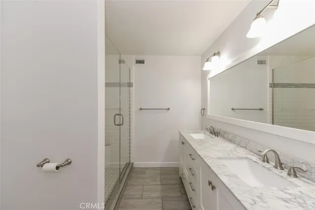 a bathroom with a granite countertop sink mirror and double