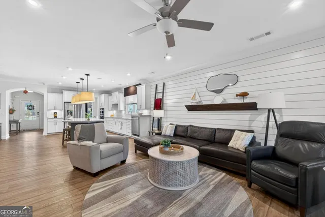 a living room with furniture and kitchen view
