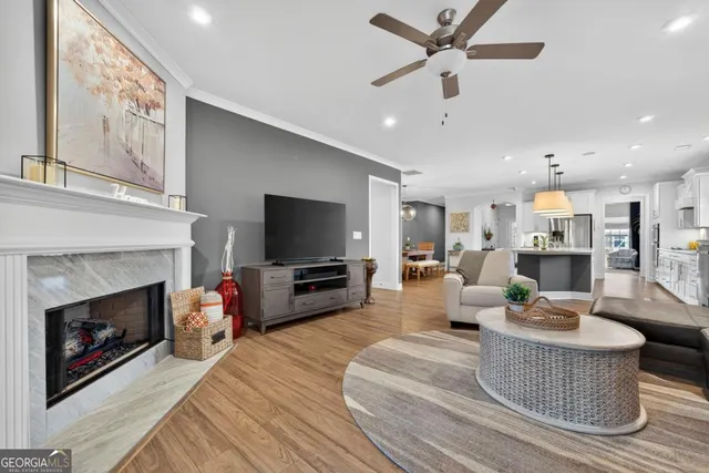a living room with furniture a fireplace and a flat screen tv