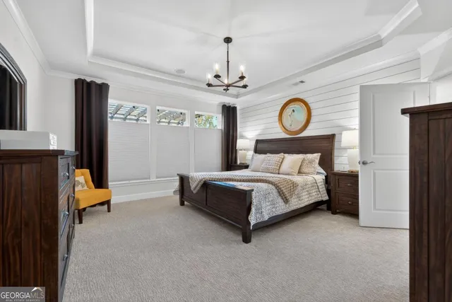 a bedroom with a bed and a clock on the wall