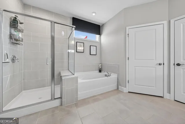 a bathroom with a bathtub and a shower