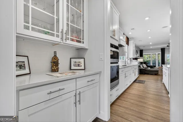 a view of a kitchen with stainless steel appliances granite countertop a refrigerator and a stove top oven