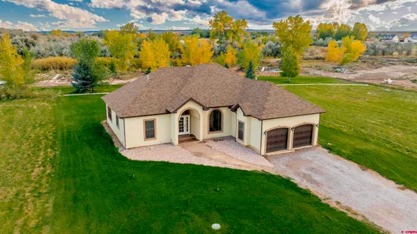 a aerial view of a house with swimming pool next to a yard