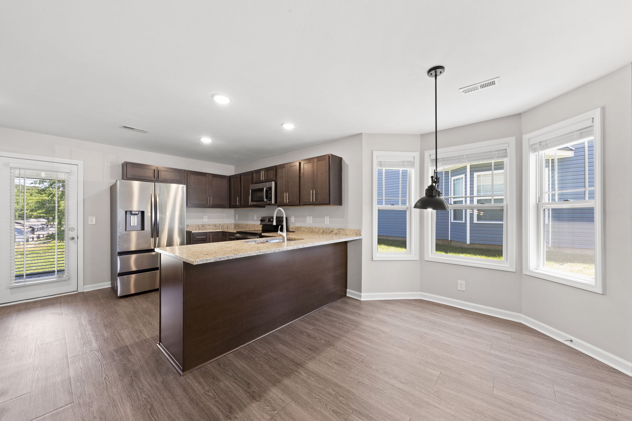 119 Davis Ridge Lane Clarksville, TN 37040 - Photo 10 of 30 a large kitchen with kitchen island a large counter top space a sink stainless steel appliances and cabinets
