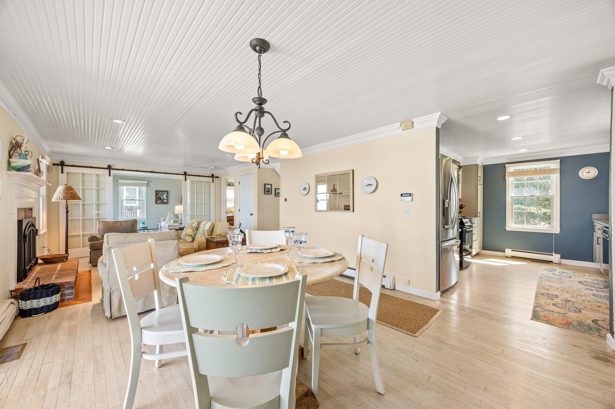 80 Hiram Pond Road Dennis, MA 02638 - Photo 11 of 82 a view of a dining room and livingroom with furniture wooden floor a chandelier