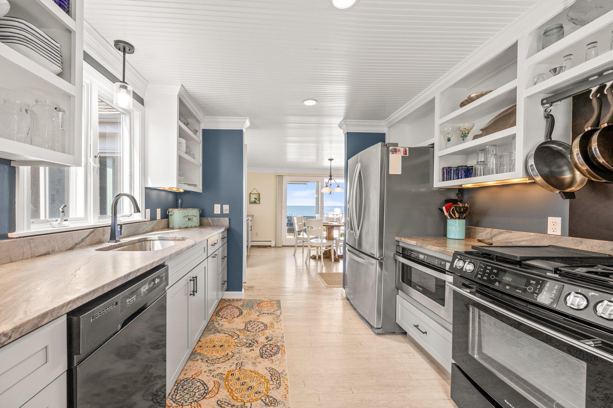 80 Hiram Pond Road Dennis, MA 02638 - Photo 14 of 82 a kitchen with stainless steel appliances granite countertop a stove and a refrigerator