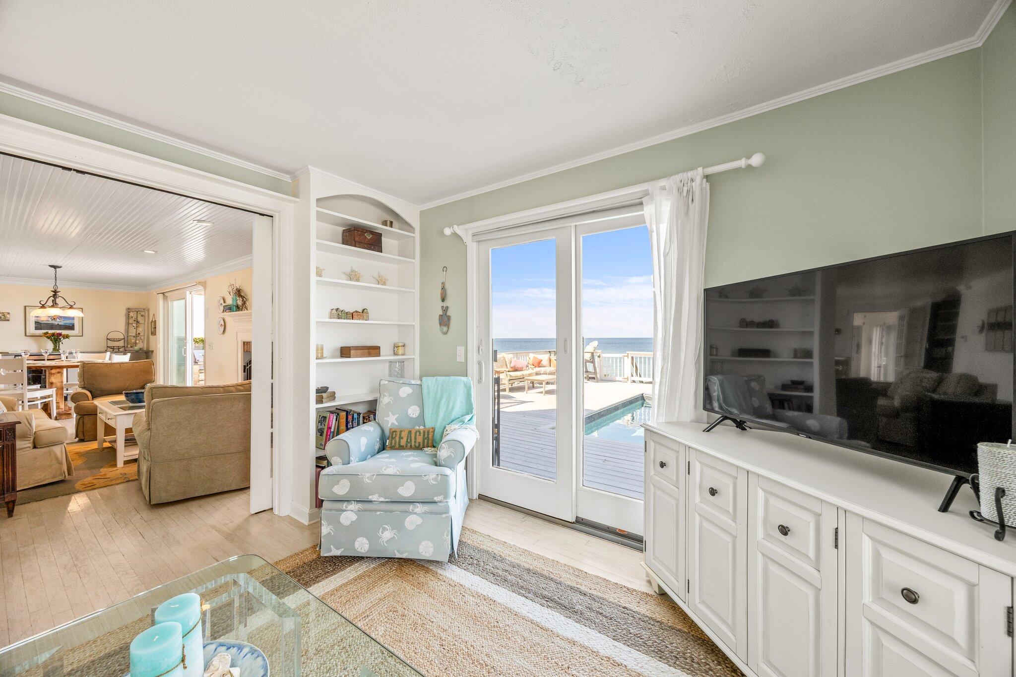 80 Hiram Pond Road Dennis, MA 02638 - Photo 17 of 82 a living room with furniture large window and a flat screen television