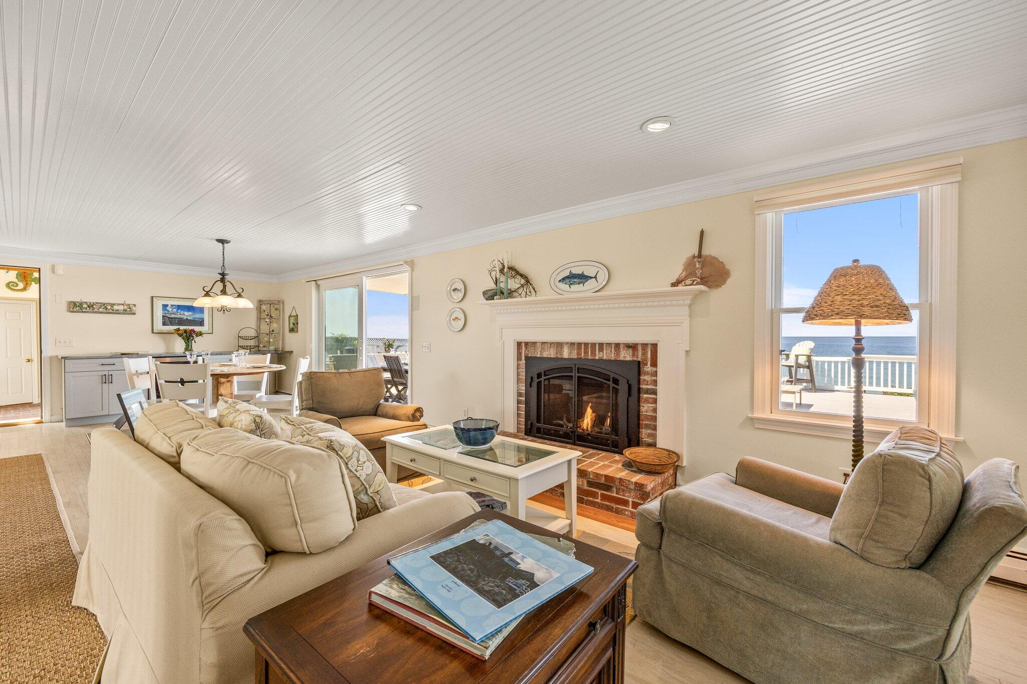 80 Hiram Pond Road Dennis, MA 02638 - Photo 19 of 82 a living room with furniture a large window and a fireplace