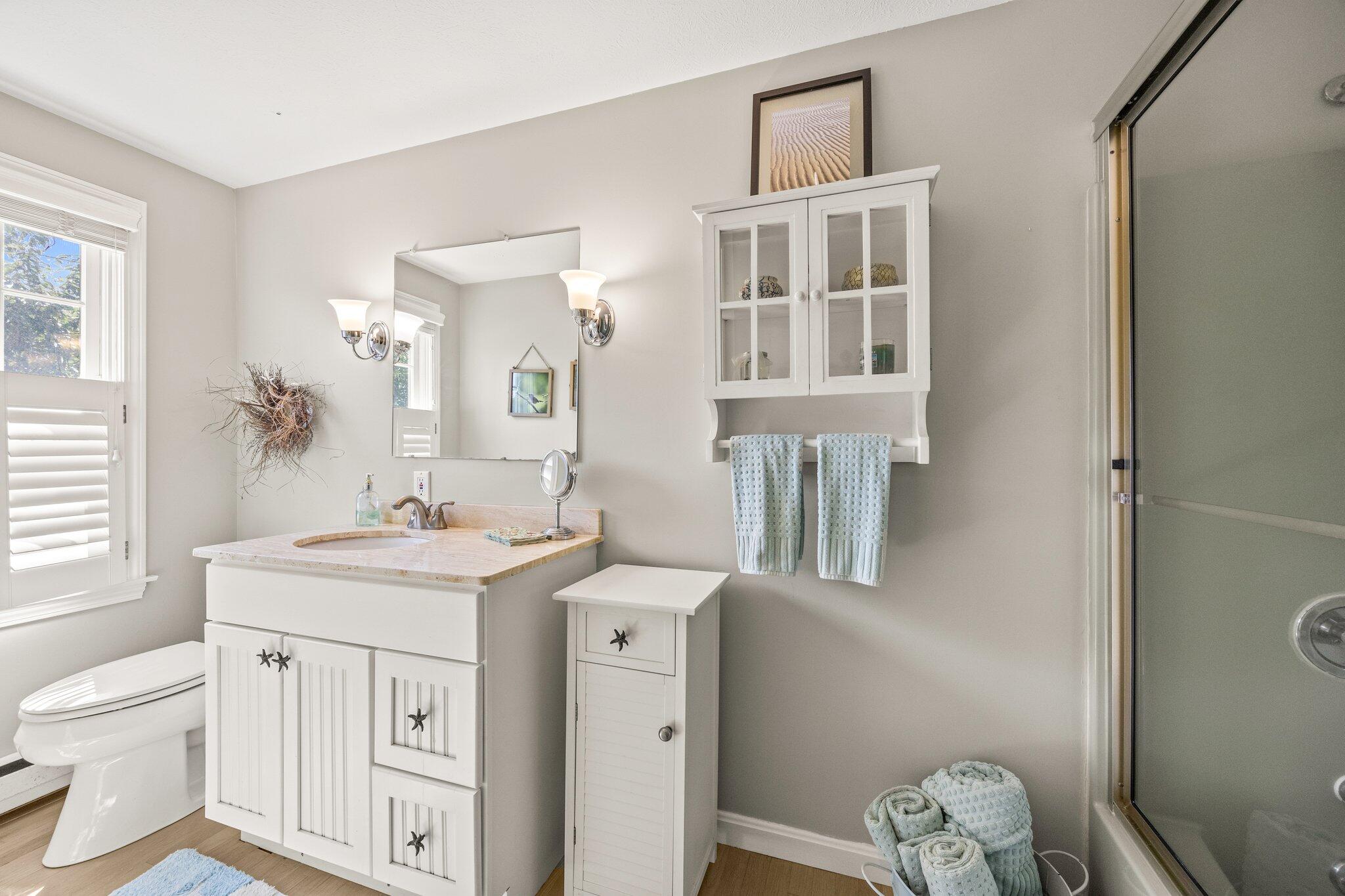 80 Hiram Pond Road Dennis, MA 02638 - Photo 23 of 82 a spacious bathroom with a toilet sink and mirror
