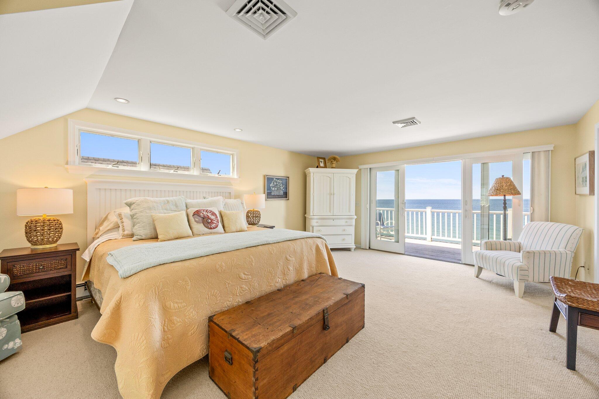 80 Hiram Pond Road Dennis, MA 02638 - Photo 25 of 82 a spacious bedroom with a bed a table and large window