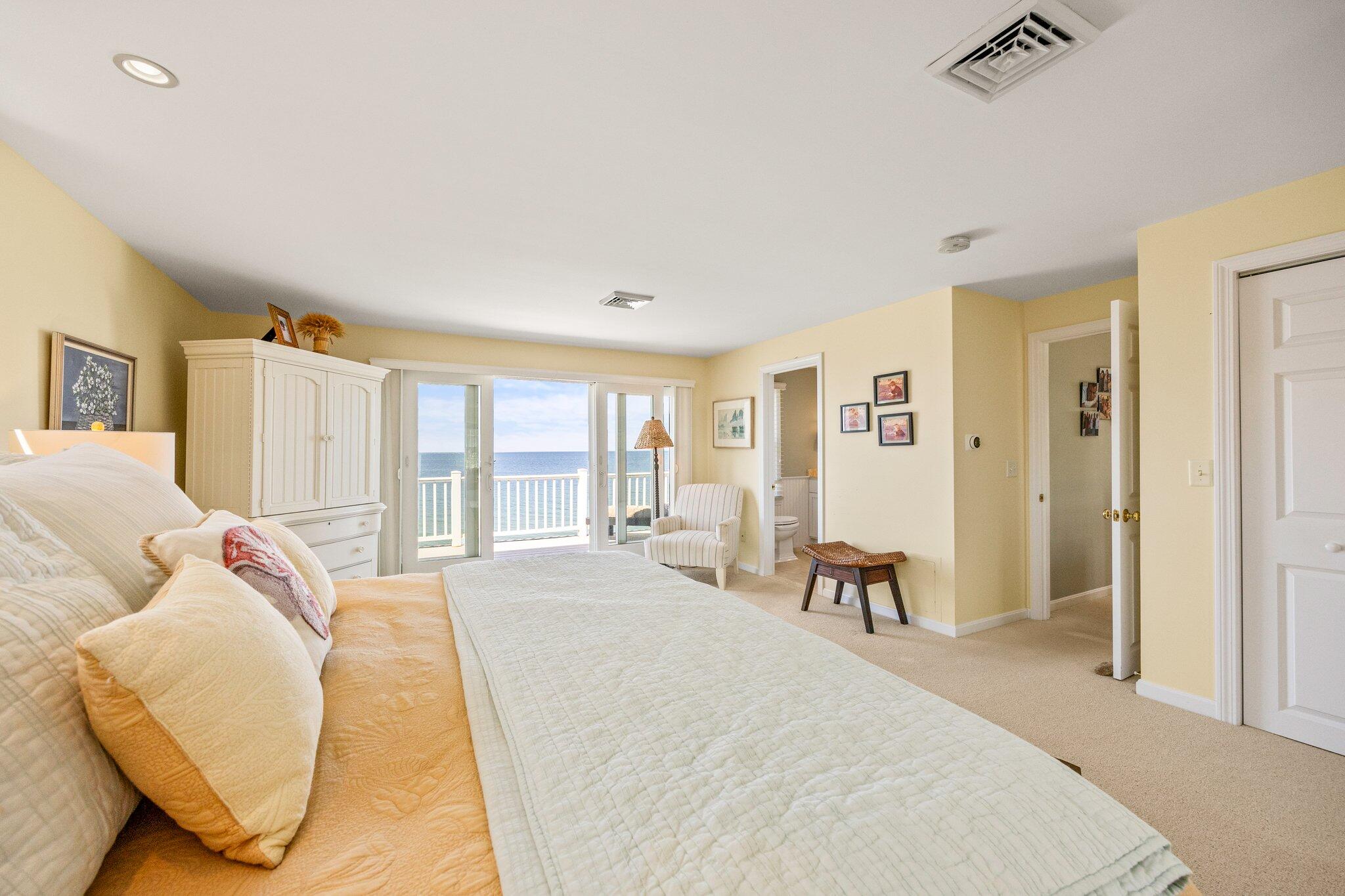 80 Hiram Pond Road Dennis, MA 02638 - Photo 27 of 82 a spacious bedroom with a bed and large windows