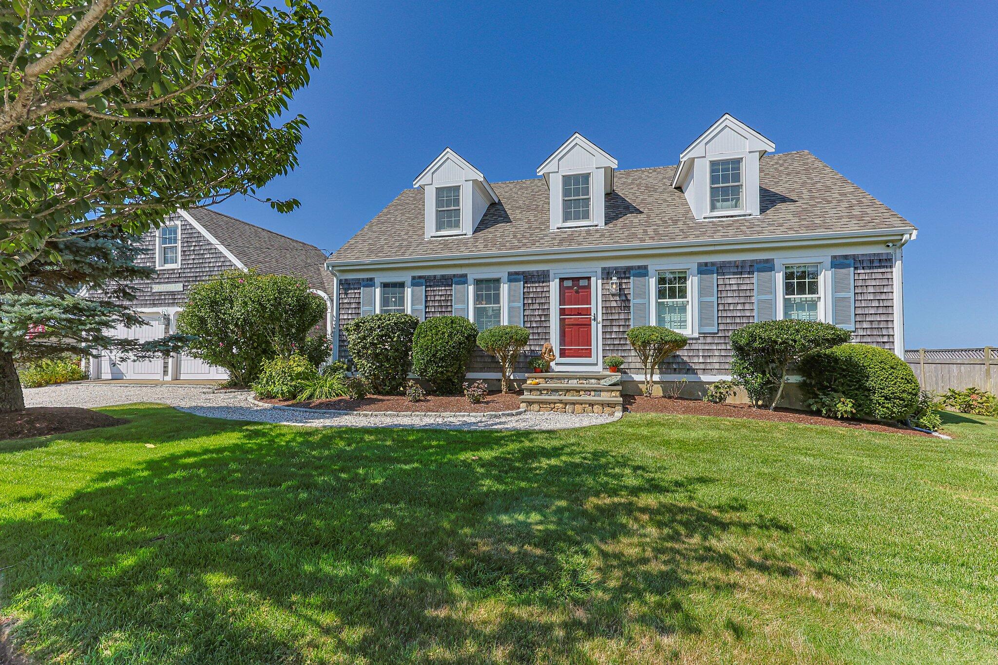 80 Hiram Pond Road Dennis, MA 02638 - Photo 3 of 82 a front view of house with yard and outdoor seating