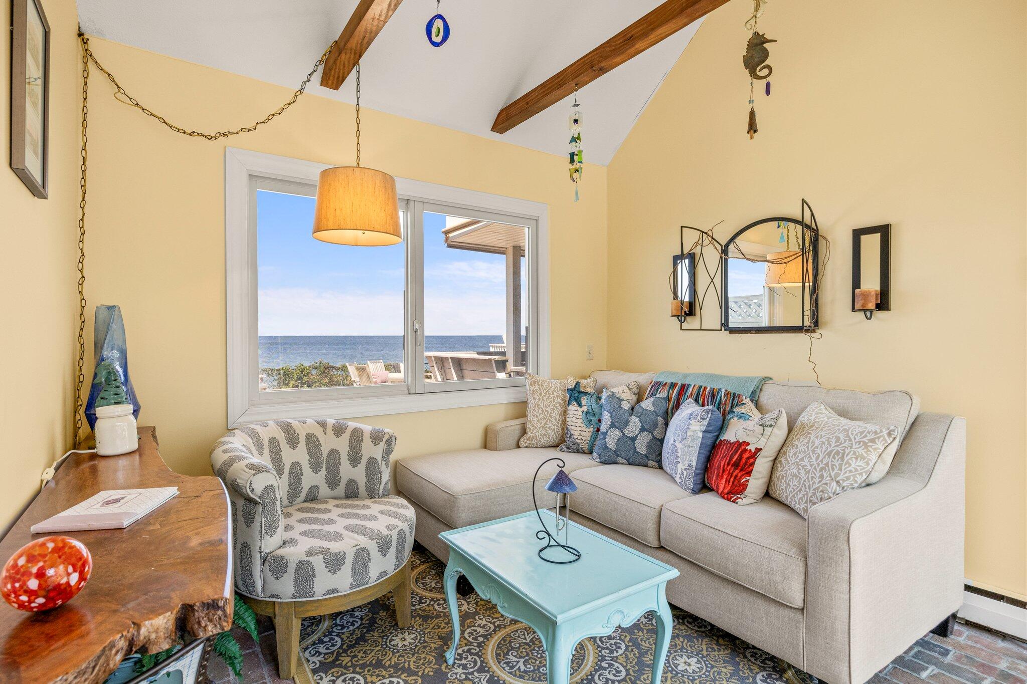 80 Hiram Pond Road Dennis, MA 02638 - Photo 37 of 82 a living room with furniture and a large window