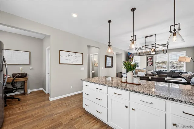 a view of living room with granite countertop furniture and wooden floor