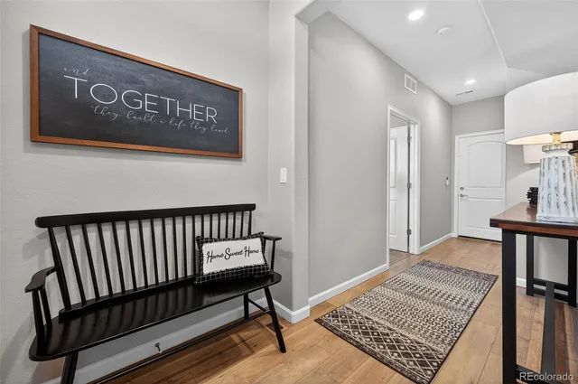 a view of hallway with a rug and a window
