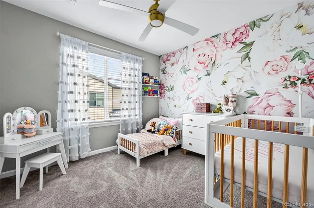 a kids bedroom with a bed and a window